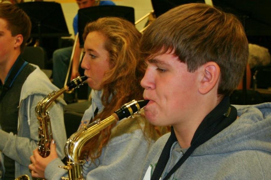 Lindsay Nofs (left) and Mike Judd practice playing the saxophone for the upcoming holiday band concert. 