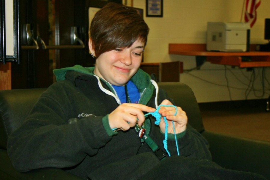 Senior Rebecca Taylor  crochets in the media center. 