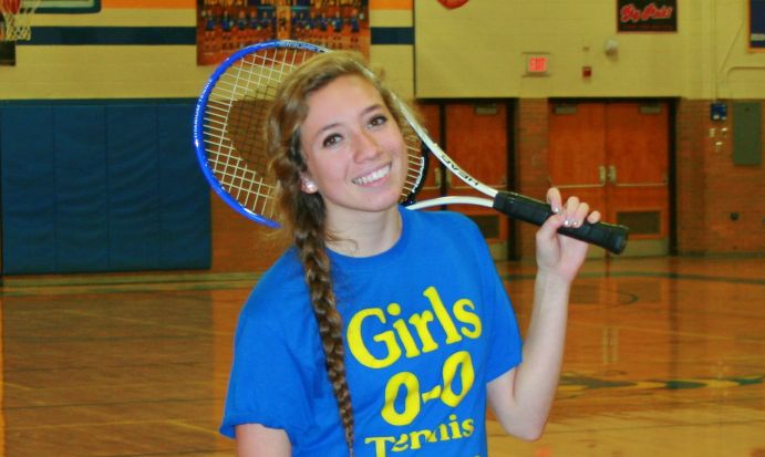Junior Lindsay Nofs poses with her tennis racquet. 
