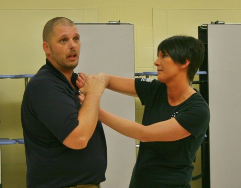 Sensei Le Willetts(left) and Mrs. Lisa Willetts demonstrate and explain a type of self-defense.