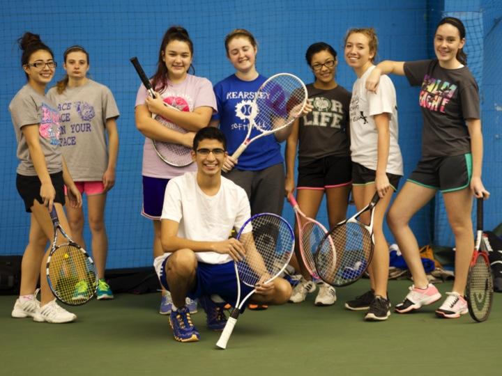 Alysa Figgins (left to right), Hailey Oryszczak, Aysia Booth, Kayla Smith, Jasmine Patrick, Lindsay Nofs, Kelsie Rose, and Santino Guerra (front) pose for a picture before practice.  The players practice at Hill Road Sports Complex.