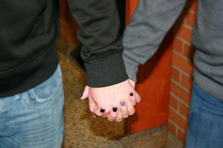 Students hold hands in the hallway after lunch. 