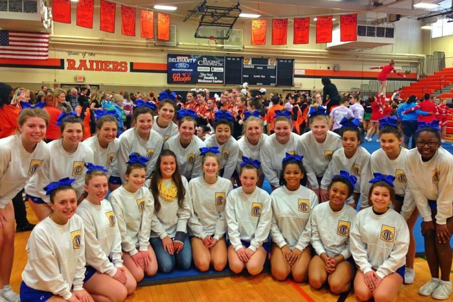 The competitive cheer team poses for a picture while waiting for their results. The Hornets finished second at the Flushing Invitational on Jan. 10.