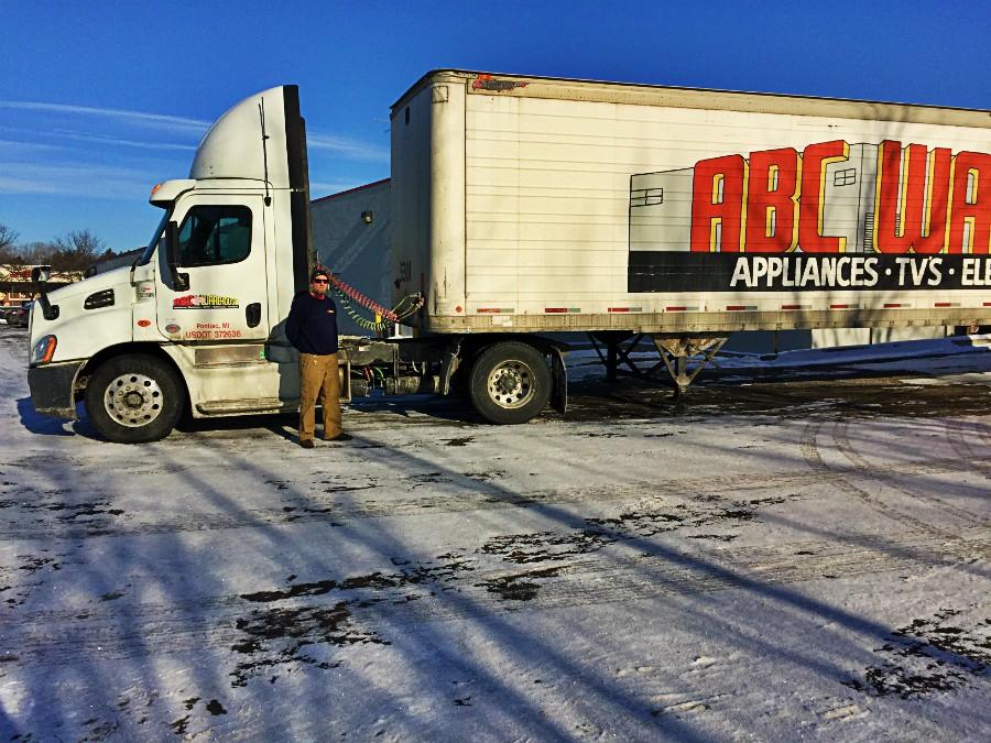 Commercial+truck+driver+for+ABC+Warehouse%2C+Mr.+Dale+Carey+stands+outside+of+his+truck.