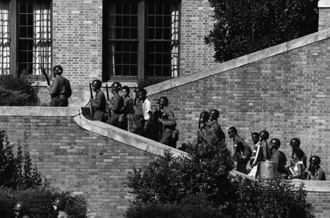 The Little Rock Nine are escorted inside Little Rock Central High School by troops of the 101st Airborne Division of the United States Army.