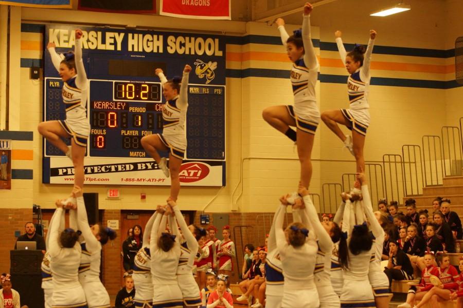 Cheerleaders+hit+their+stunts+for+round+three.+The+Hornets+finished+as+runners+up+at+their+home+competition+on+Feb.+7.+