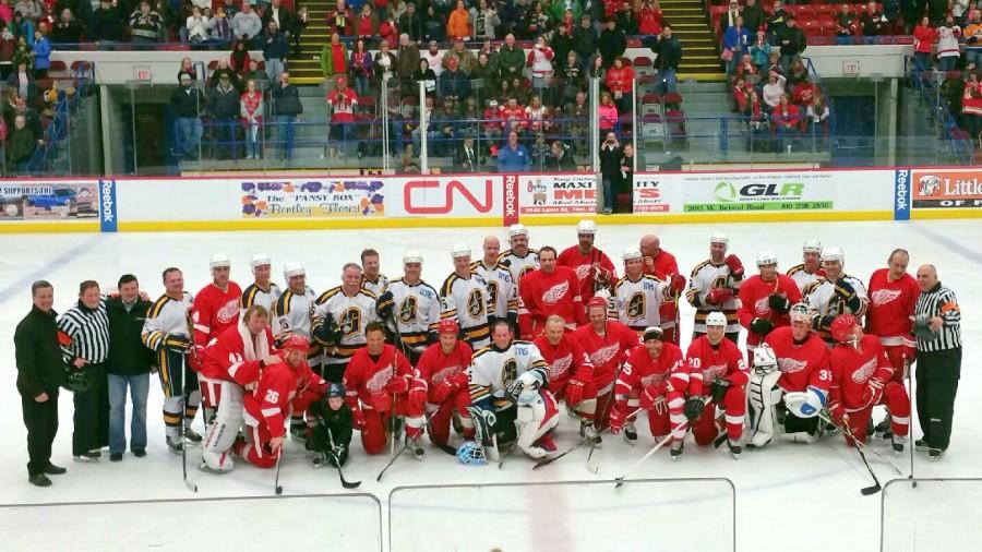 Alumni Red Wing and Flint Generals players pose for pictures after the game on Feb. 20. 