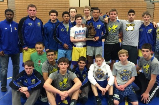 The wresting team poses with its district championship trophy on Feb. 11.