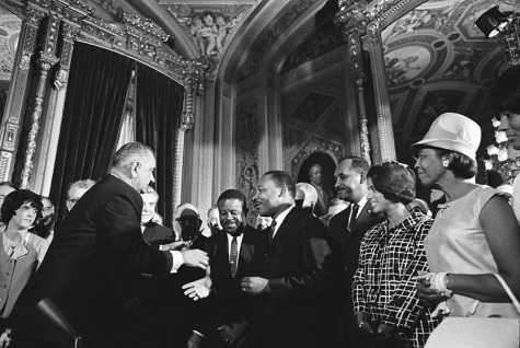 President Lyndon B. Johnson meets with the Rev. Dr. Martin Luther King Jr. at the signing of the Voting Rights Act of 1965.