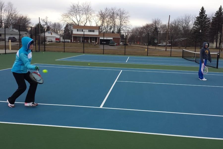Juniors Kelsie Rose (left) and Jasmine Patrick practice playing a doubles match on March 23. Both of these girls are actively involved in extracurricular activities.