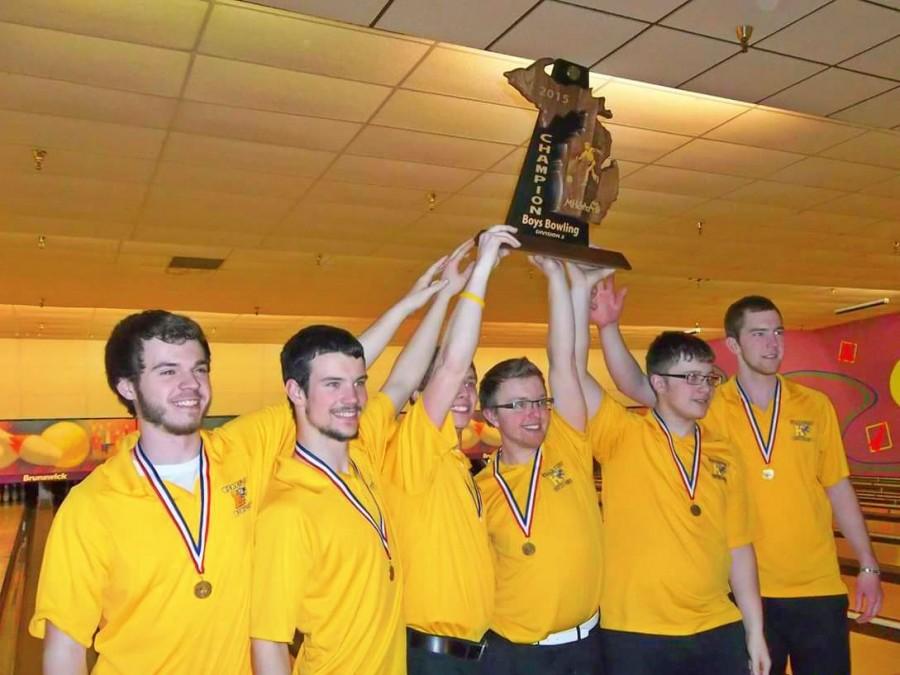 The boys bowling team poses with its first-place trophy from the state final on March 6.  