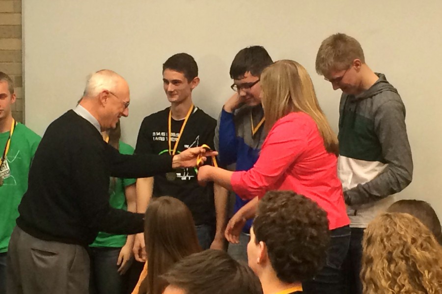 Seniors Dylan Brewer (left), Ben Roof, Ruth Erickson, and Aaron Haack receive medals at the 10th annual Mott Math Competition on March 20. They tied with a team from Flushing. 