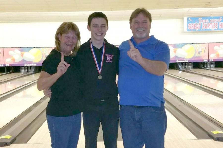 Junior Chad Stephen celebrates his Division 2 singles state title with his parents on March 7 at Century Bowl in Waterford.