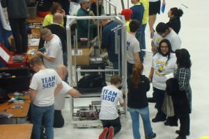 The team works on their robot in between qualification matches.  The pits were filled with participating teams working on bots and spectators.
