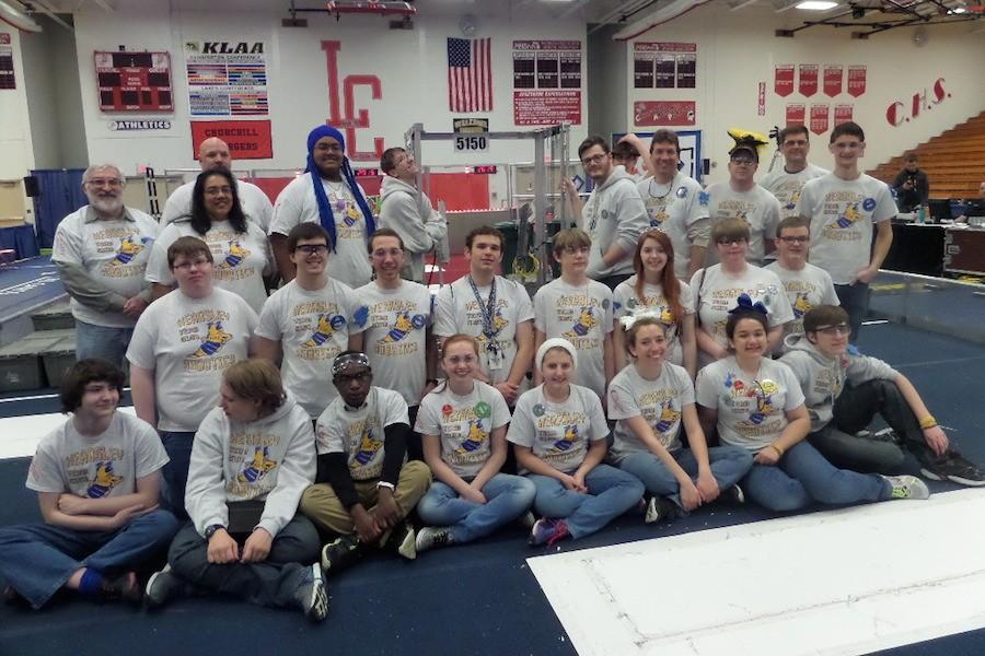 Team 5150 stands with their robot following the first day of the Livonia Churchill District competition on March 27.