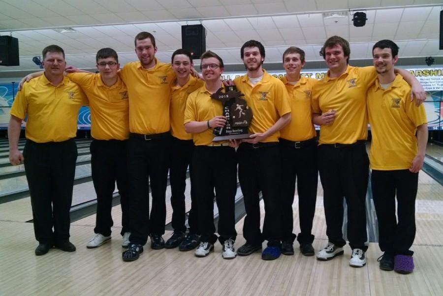 The boys bowling hoists the regional trophy after winning the regional competition two years in a row. 