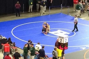 Senior James Davis (yellow headgear) wrestles Logan Massa of St. Johns in the second round of the Division 2 individual state final March 7 at the Palace of Auburn Hills. Massa defeated Davis and went on to win the state title. Davis ended up with All-State recognition, placing fourth.
