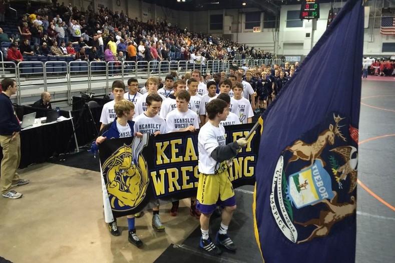 The+wrestling+team+marches+in+the+opening+ceremony+of+the+MHSAA+state+finals+in+Battle+Creek+on+Feb.+27.