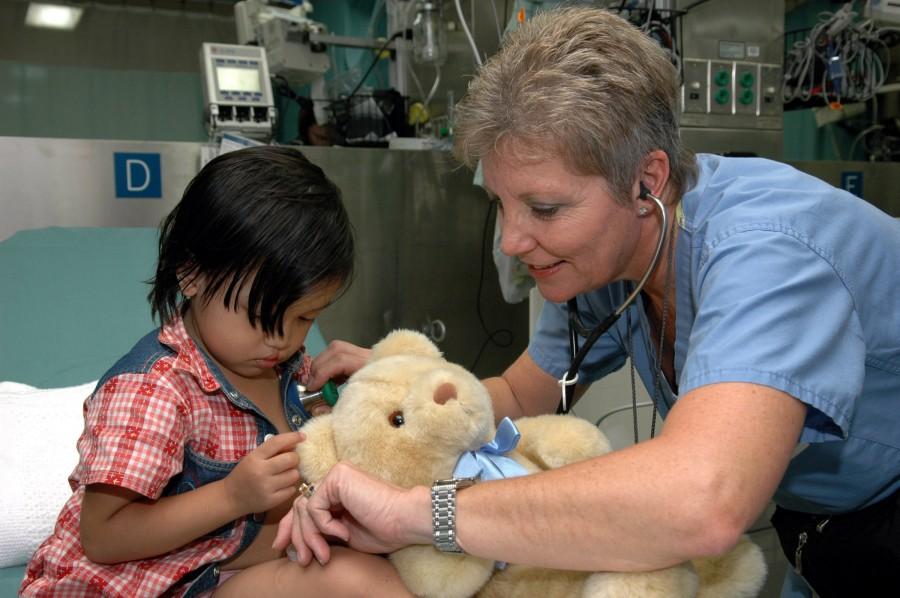 Project Hope nurse, Ms. Diane Speranza listens to a child's heartbeat while aboard the U.S. Military Sealift Command (MSC) Hospital ship USNS Mercy (T-AH 19). 