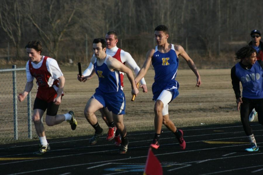 Sophomore Darrion Younger hands off the baton to junior Matt Parkinson in the sprint medley relay. This relay team won the event at the Kearsley Early Bird Relays on April 1.