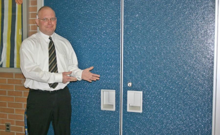 Assistant Principal Matt Moore shows off one set of new doors to the gymnasium.