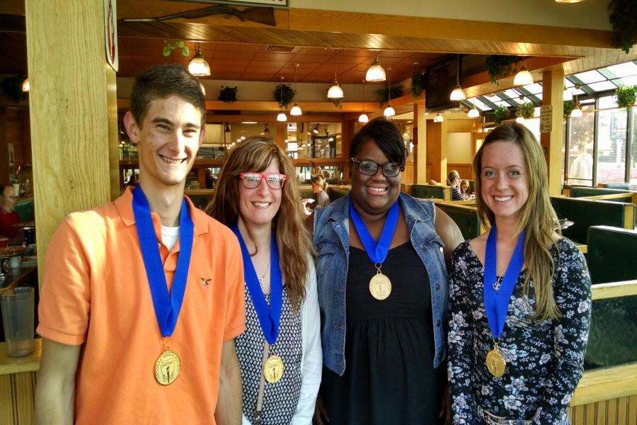 The outgoing National Honor Society officers Dylan Brewer (left), Miranda Blaine, Kayla Knight, and Teagan MacDonald were given medals on May 21 at the NHS banquet at Little Caesars.