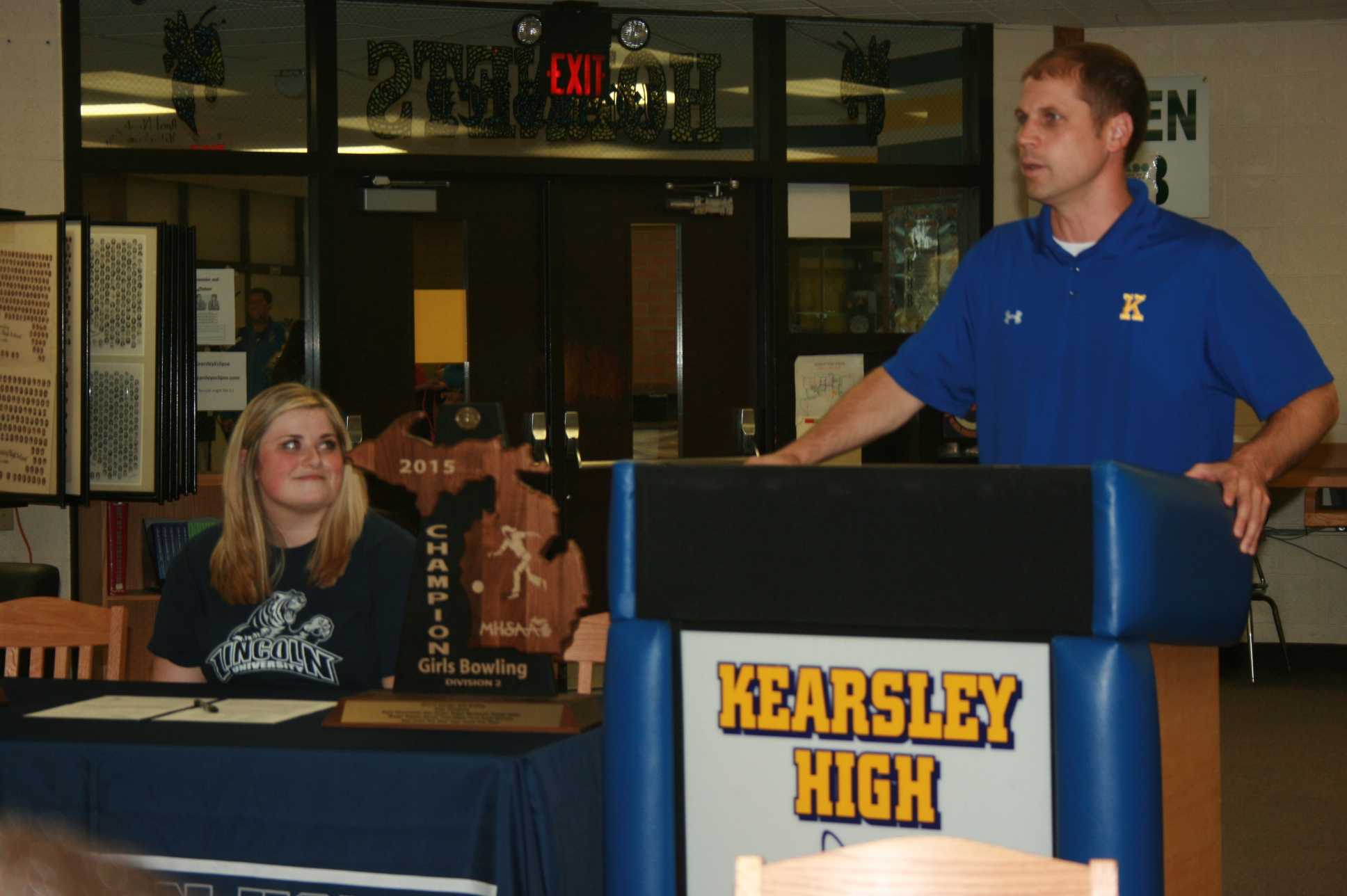 Senior Dani Doolan (left) waits to sign her National Letter of Intent while Athletics Director Paul Gaudard speaks to begin the ceremony.