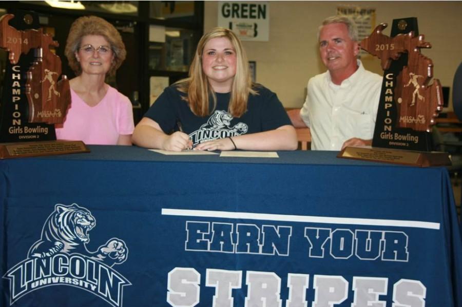 Senior Dani Doolan signs her National Letter of Intent on May 8 to bowl at Lincoln University (Mo.) supported by her parents.
