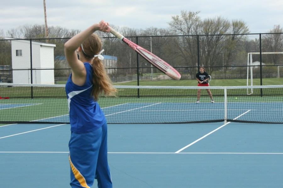 Senior Hailey Oryszczak, at No. 3 singles,  serves against Swartz Creek on April 30 at home. 