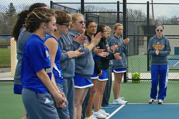 The+tennis+team+lines+up+for+player+introductions+before+its+home+match+against+Swartz+Creek+on+April+30.+