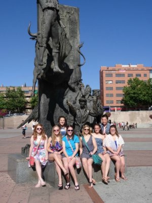 Ms. Laura Pence and her Spanish students pose in front of a monument at the bull-fighting arena.