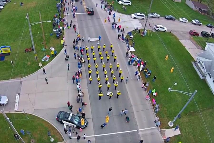 The marching band walks the parade. Image captured by a drone.