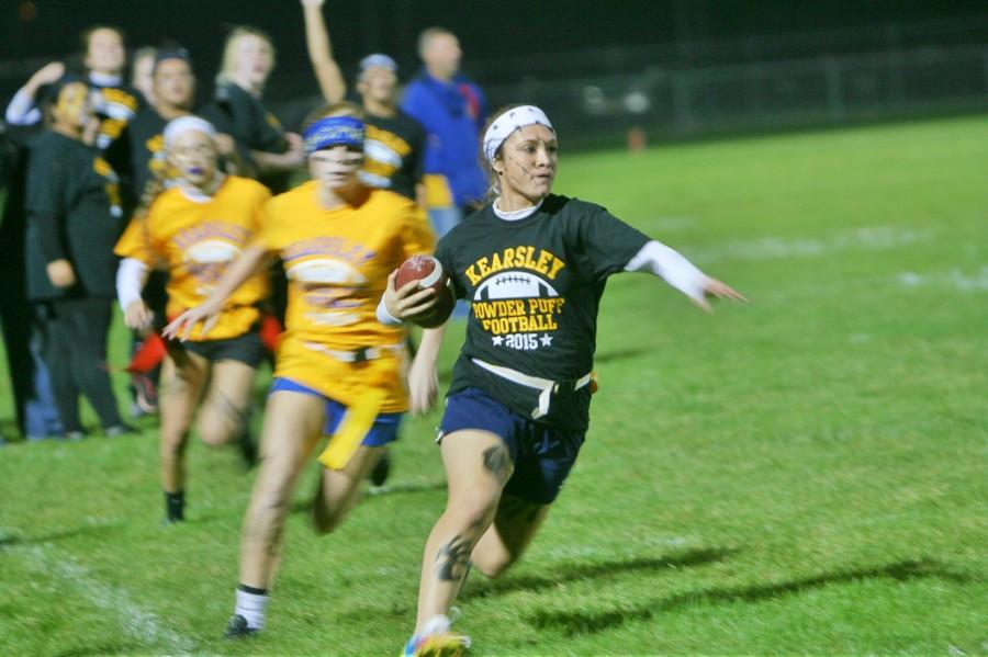 Senior Neci Dell runs away from the defenders in the senior-sophomore game.