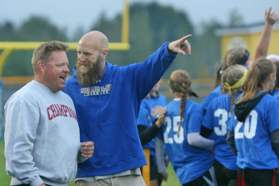 Coach Jack Linn (left) and Coach Rob Markwardt discuss a previous play during a timeout in the junior-freshman powder puff semifinal Monday, Oct. 5.