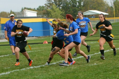 Tori Niles, senior quarterback, handles the ball as the teams trail behind.