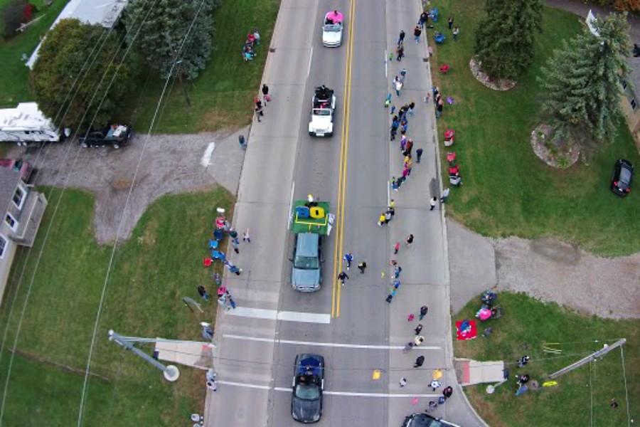 The Senior Class float, trailed by cars toting members of homecoming court, is seen in the eyes of a drone.