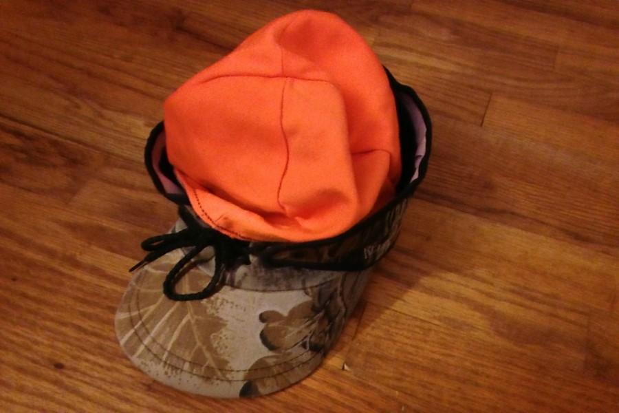 Hunting+safety+requires+hunters+to+wear+clothing+like+this+hat+because+it+is+hunter+orange.