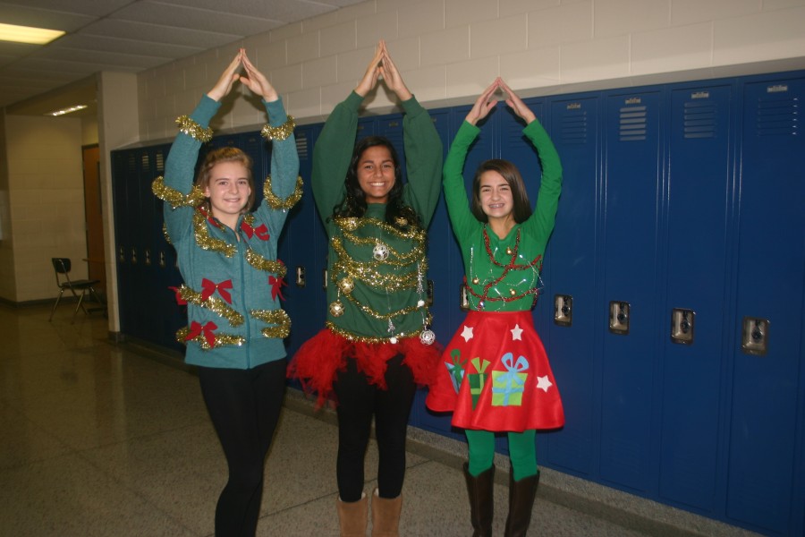Freshmen Mallory Simms (left), Mickeely Dias, and Emma Bishoff are rocking around the Christmas tree showing off their festive outfits.