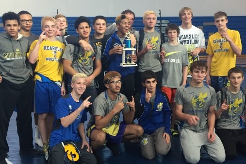The wrestling team shows off its championship trophy after winning the Croswell-Lexington Invitational on Saturday, Dec. 19.