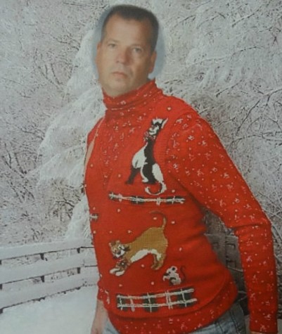 Mr. Paul Adas poses model-style in his ugly Christmas sweater.