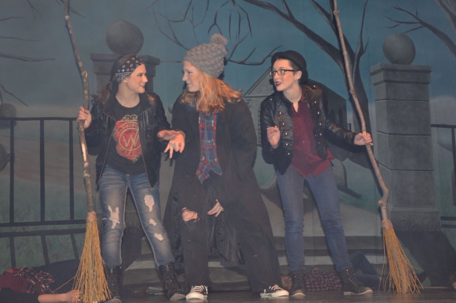 Playing a scene as witches in Mmmbeth during a dress rehearsal, senior Julie Lemon (center) talks to junior Emily Harper (left) while senior Taylor Stockton listens.