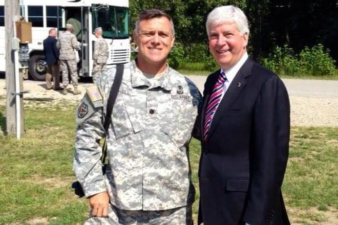 Lt. Col. John Hall talks with Gov. Rick Snyder at Camp Grayling in Michigan.