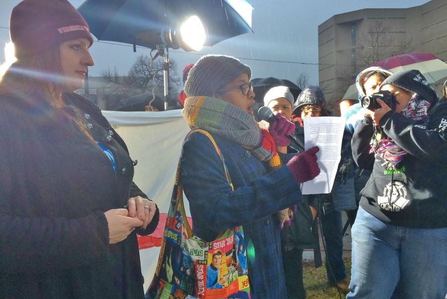Ms. Nayyirah Shariff (center) addresses the crowd at a Flint water protest at city hall Friday, Jan. 8.