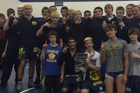 The wrestling team shows off the Marysville Gatorade Duals trophy on Saturday, Jan. 16, after winning the tournament.