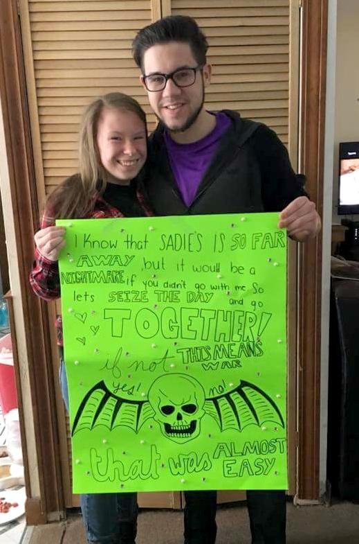 Seniors Shelby Cantrell and Adam Chuchvara pose with the poster Cantrell made for him, asking him to the Sadie Hawkins dance. 