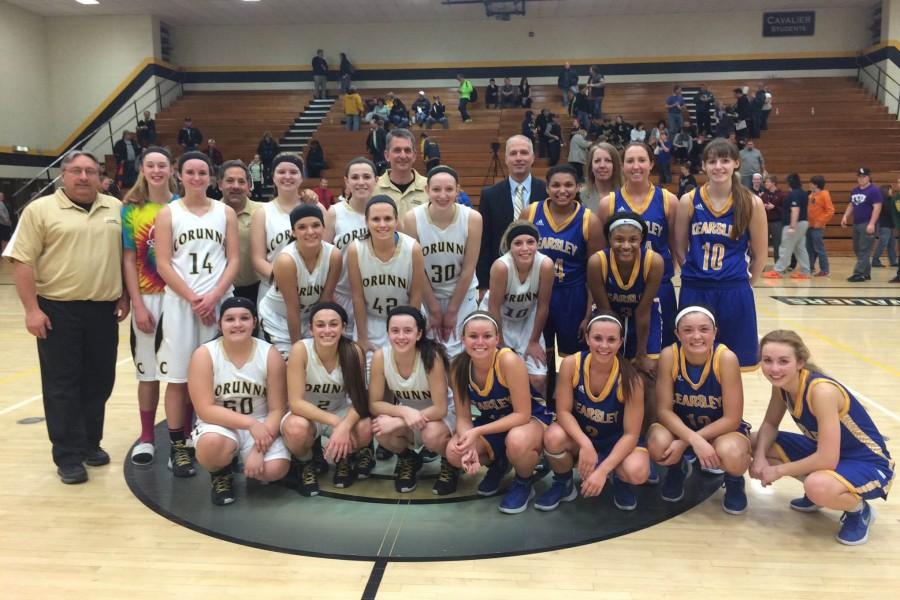 The Corunna Cavaliers and Kearsley Hornets pose after a game that is part of the inaugural Coaches vs. Cancer Challenget between teams from the Genesee Area Conference and the Flint Metro League. Corunna hosted the contest Monday, Feb. 22. 