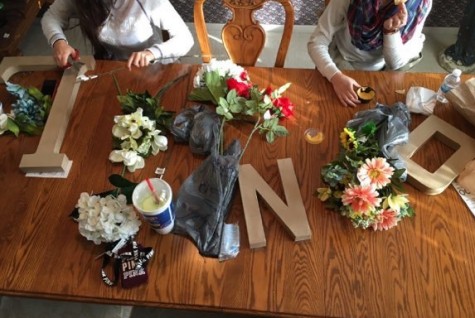 Cardboard letters can be covered with fake flowers.