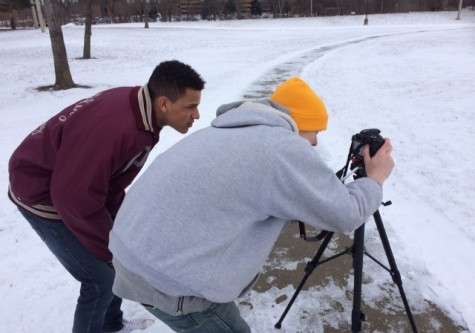 (left to right) seniors Alec Pennell and Coi Jenkins set up the camera in downtown Flint