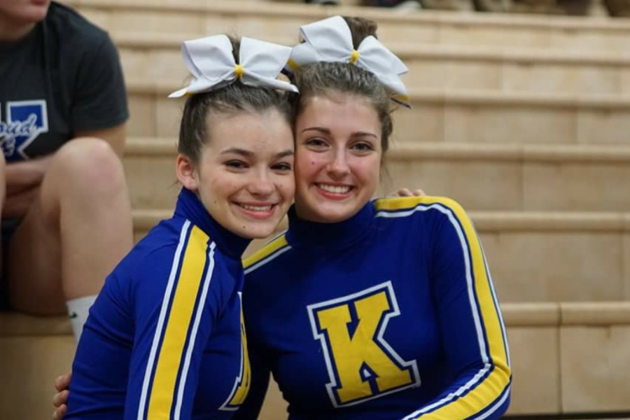 Juniors Kassidy Krist (left) and Hailey Baltosser smile at a cheer competition. 