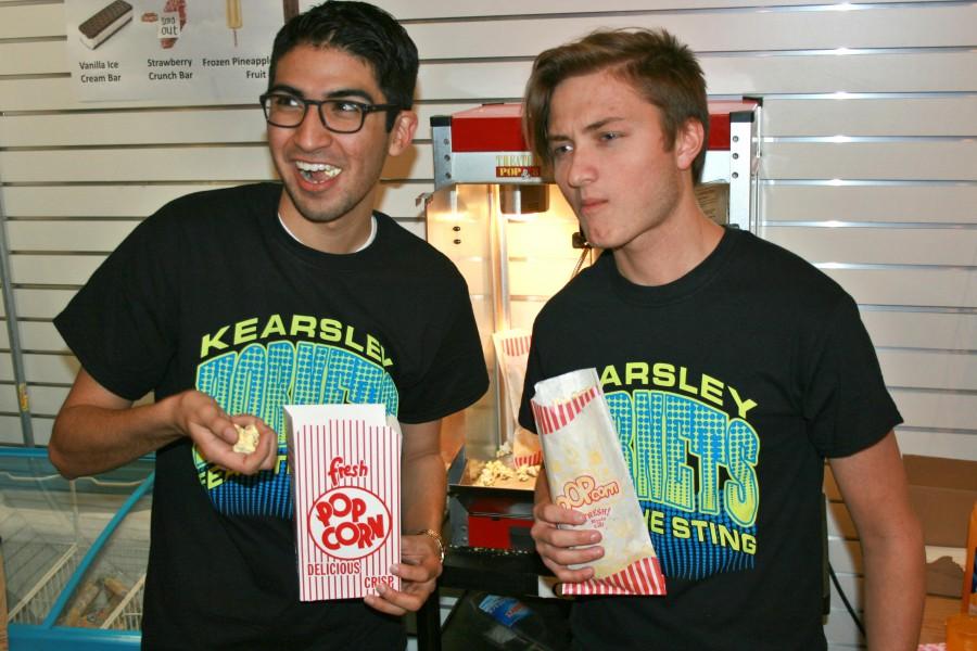 Seniors Santino Guerra (left) and Andrew Edwards enjoy some popcorn in the Hornets Nest while wearing a K-Town Tees design.